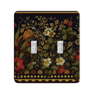 May include: A decorative light switch cover with a floral pattern in shades of red, yellow, green, and white on a black background. The switch cover has a gold border with a scalloped edge. The words "OFF" are printed on the two toggle switches.