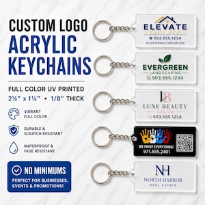 May include: Five rectangular acrylic keychains with metal rings, featuring custom logos for Elevate Realty Group, Evergreen Landscaping, Luxe Beauty Salon, a handprint design with a QR code, and North Harbor Real Estate. Dimensions are 2.25 by 1.25 inches.