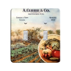 May include: A vintage-style light switch plate featuring a colorful illustration of a garden scene with vegetables and the text "A. Currie & Co. 130 Wisconsin Street Milwaukee.Wis. Garden and Farm Seeds Spring 1912".
