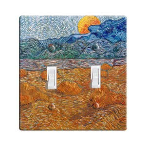 May include: A light switch cover featuring a painting of a landscape with a bright yellow sun in the sky. The landscape is painted in a style reminiscent of Vincent van Gogh, with swirling brushstrokes and vibrant colors. The switch cover has two toggle switches labeled "OFF".