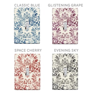 May include: Four light switch covers with a damask pattern in different colors: classic blue, glistening grape, space cherry, and evening sky.