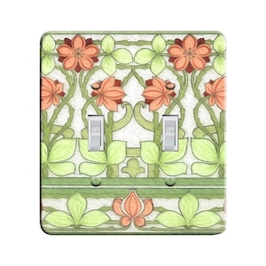 May include: A light switch plate with a floral design featuring green leaves, orange flowers, and a white background. The plate has two toggle switches labeled "OFF".