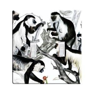 May include: A black and white light switch cover featuring a pattern of monkeys in a jungle setting. The monkeys are drawn in a vintage style and have black and white fur. The switch cover is made of durable plastic and is easy to install.