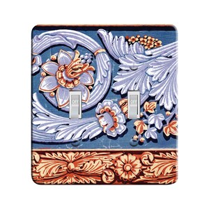 May include: A light switch cover with a vintage floral design in shades of blue, purple, orange, and red. The design features a repeating pattern of stylized flowers and leaves. The switch cover has two toggle switches labeled "OFF".