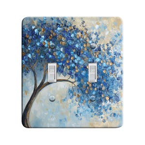 May include: A light blue and gold abstract painting of a tree with leaves, with the words "OFF" on two light switch toggles.