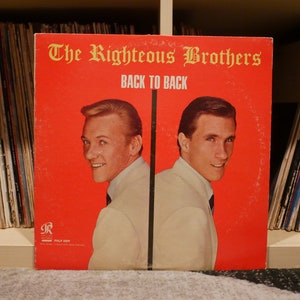 May include: A red vinyl record album cover featuring The Righteous Brothers with the title "Back to Back".