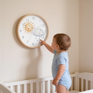 May include: A round wall clock with a light wood frame and a white face. The clock features a cartoon sun and a rain cloud with raindrops. The numbers one through twelve are printed in black around the perimeter, with white hour and minute hands.