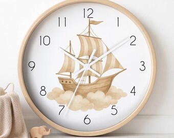 May include: A round wall clock with a light wood frame and a white face. The centre features a watercolour illustration of a brown sailing ship floating on light brown clouds. The clock has black numerals from 1 to 12 and thin white clock hands.