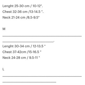May include: Size chart for clothing with measurements in inches and centimeters.  Sizes include S, M, and L.  Measurements include length, chest, and neck.