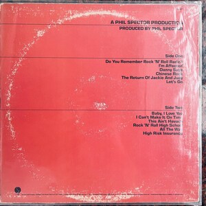 May include: Red album cover with black text listing song titles, including "Do You Remember Rock 'N' Roll Radio" and "Baby, I Love You." The text reads "A Phil Spector Production" and "Produced by Phil Spector."