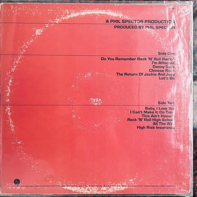 May include: Red album cover with black text listing song titles, including "Do You Remember Rock 'N' Roll Radio" and "Baby, I Love You." The text reads "A Phil Spector Production" and "Produced by Phil Spector."