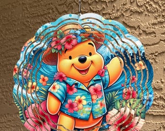 May include: A colorful metal wind spinner featuring a smiling bear wearing a Hawaiian shirt and hat, surrounded by tropical flowers and a blue ocean design. The wind spinner is designed with a wavy, layered effect.