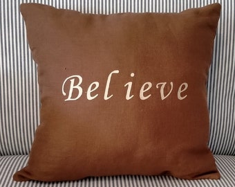 Teal and Coco Collection - Linen Cushion - Medium in Coco - 32 cm Square - with gold lettering of the word Believe