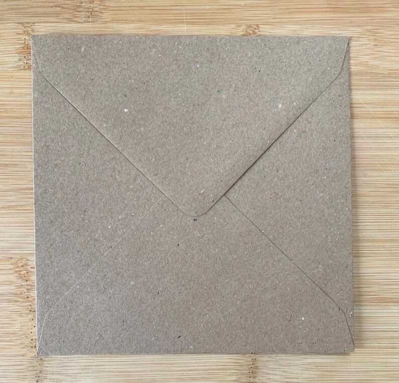 May include: A square envelope made of light brown, textured kraft paper. The envelope features a triangular flap that folds down to the center, creating a clean, simple design with visible paper fibers throughout the surface of the material.