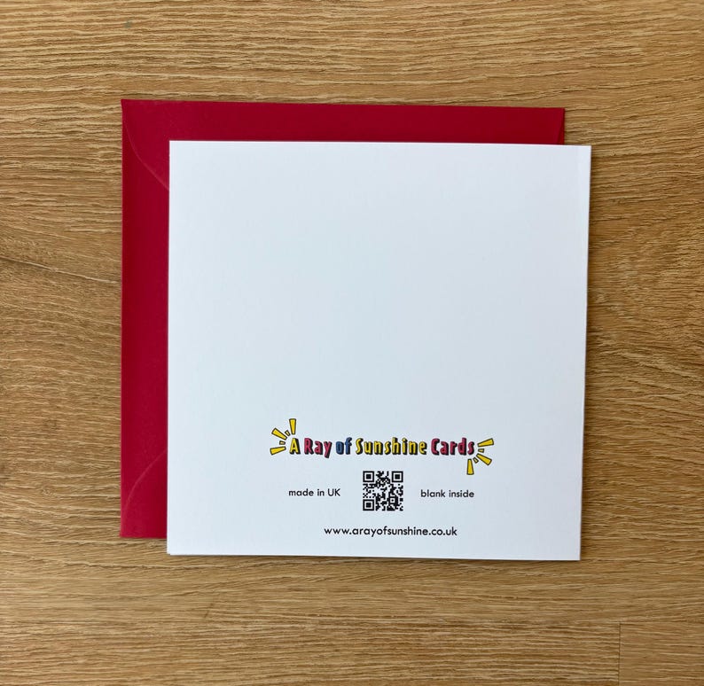 May include: A white greeting card with a red envelope. The card has the text "A Ray of Sunshine Cards" and a QR code. The card is blank inside and made in the UK. The website address is also included.