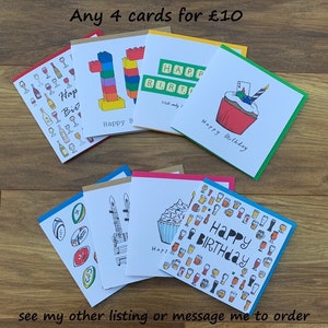 Peut inclure: Plusieurs cartes de v&oelig;ux faites &agrave; la main avec des illustrations vari&eacute;es, dont un cupcake, des verres &agrave; vin et un nombre 10 en style Lego. Les cartes ont des bordures color&eacute;es et les mots "Happy Birthday". Le texte "Any 4 cards for &pound;10" est &eacute;galement visible.