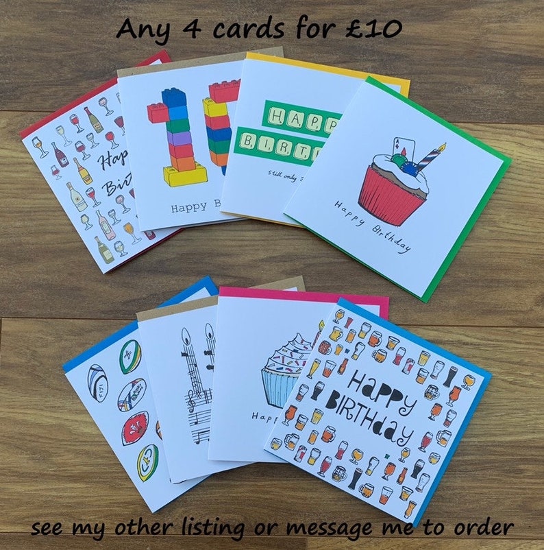 Peut inclure: Plusieurs cartes de v&oelig;ux faites &agrave; la main avec des illustrations vari&eacute;es, dont un cupcake, des verres &agrave; vin et un nombre 10 en style Lego. Les cartes ont des bordures color&eacute;es et les mots "Happy Birthday". Le texte "Any 4 cards for &pound;10" est &eacute;galement visible.