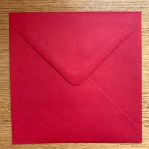 May include: A red envelope with a white flap.
