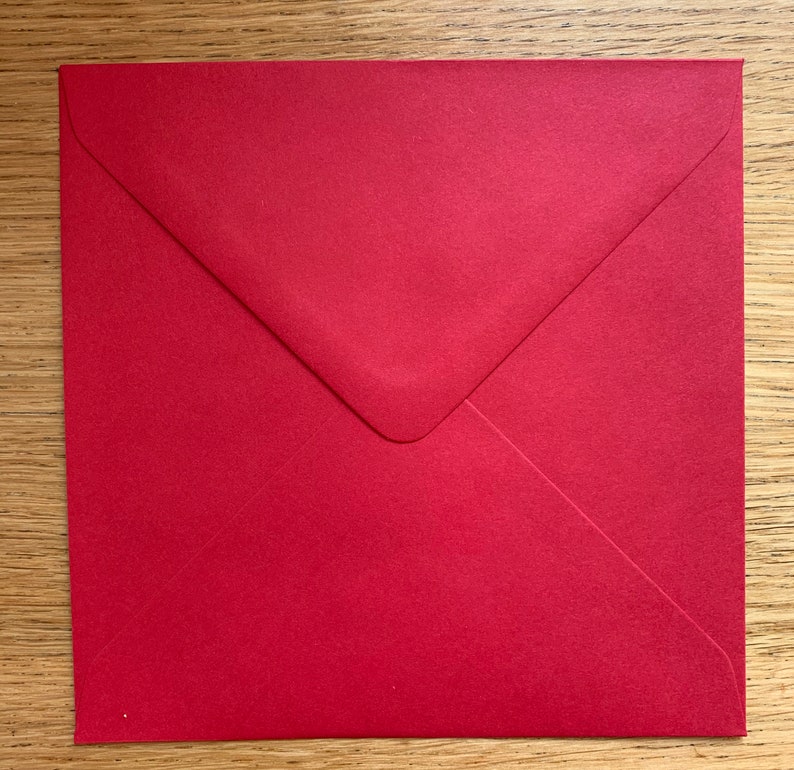 May include: A red envelope with a white flap.