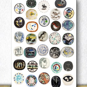 May include: A collection of 36 ceramic plates with various designs, including faces, animals, and abstract patterns. The plates are white with colorful designs and are arranged in a grid pattern.