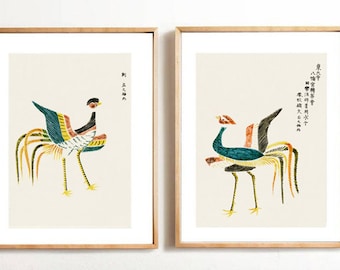 May include: Two framed prints of stylized illustrations of birds with long, colorful tails. The prints are on a white background and feature Japanese text.