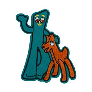 May include: Embroidered patch featuring the cartoon characters Gumby and Pokey. Gumby is teal with red eyes and a yellow smile, and Pokey is orange. The patch has a black border and is on a white background.