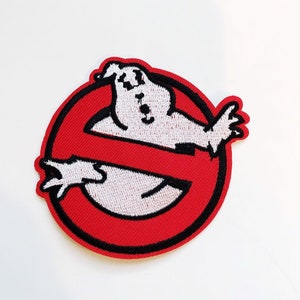 May include: Red and black embroidered patch with a white ghost in the center. The ghost is in a no symbol.