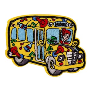 May include: Embroidered patch featuring a yellow school bus with blue windows and black tires. The bus is decorated with musical notes, red megaphones, and blue bells. A woman with red hair is visible in the driver's seat.