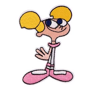 May include: Embroidered patch featuring a cartoon character with yellow hair, blue eyes, and a pink dress. The character is smiling and has their hands clasped in front of them. The patch is outlined in black.