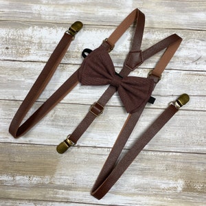 May include: Brown leather suspenders with gold-tone clips and a matching brown bow tie.