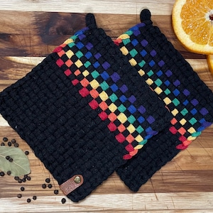 May include: Two black woven pot holders with rainbow colored checkered trim and leather loops.