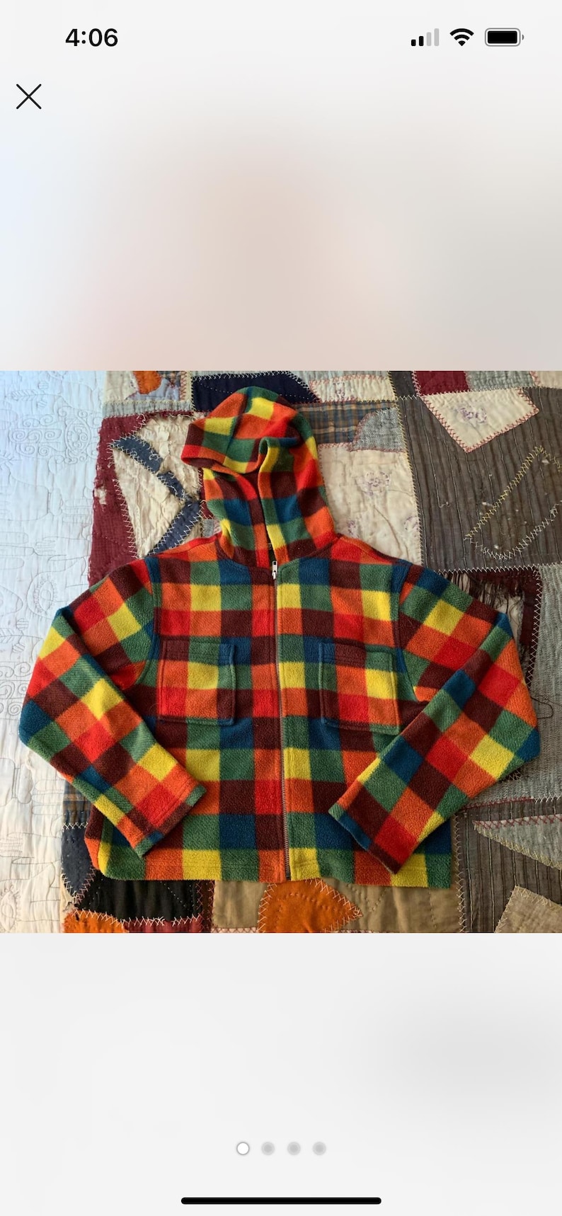 May include: A hooded jacket with a vibrant plaid pattern in red, yellow, green, and blue. The jacket has a full zipper, two front pockets, and a cozy, textured appearance. The colorful design makes it a standout piece.