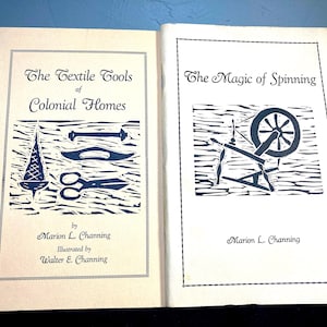 May include: Two vintage books open side-by-side. The left book cover reads "The Textile Tools of Colonial Homes" with illustrations of tools. The right book cover reads "The Magic of Spinning" with a spinning wheel illustration. Both books are by Marion L. Channing.