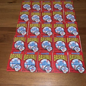 Lote de 25 tarjetas de béisbol Fleer de 1991, selladas y sin abrir. 14 sobres + calcomanía.