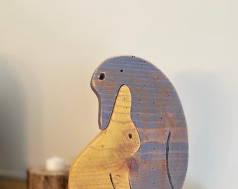 Rustic wood mother and baby penguin