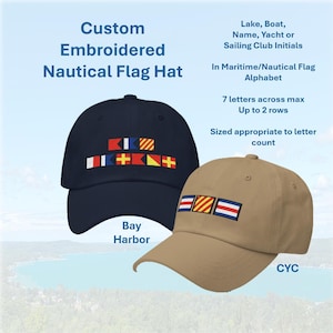 May include: Two custom embroidered nautical flag hats. One navy blue hat with colorful flag designs and the text "Bay Harbor". The other is tan with flag designs and the initials "CYC". The hats are designed with maritime/nautical flag alphabet.