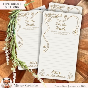 May include: Ivory-colored bridal shower cards with gold floral and ribbon accents. The cards read "For the Bride" and include space for notes. The text "Alli's Bridal Shower" is also visible. The image also shows the text "Five Color Options".