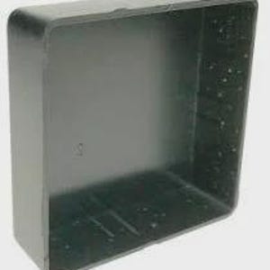 May include: A black, square plastic container with rounded corners. The container has a hollow interior and a textured surface on the inside. The container is designed to hold items and has a simple, utilitarian design.
