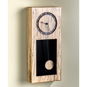 May include: A rectangular wooden wall clock with a black clock face and a pendulum. The clock face has white numerals and hands. The wooden frame has a unique grain pattern. The pendulum swings within a rectangular opening.