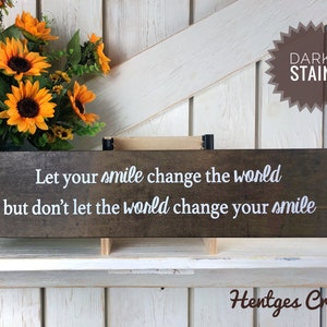 Let you're smile change the world but don't let the world change your smile sign