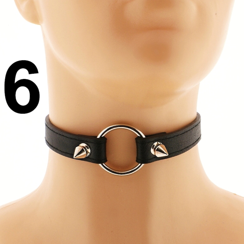 With its heart ring, spiked design, and adjustable buckle closure, this vegan leather choker in all-black is a stylish accessory that is ideal for those who love punk or rock fashion.