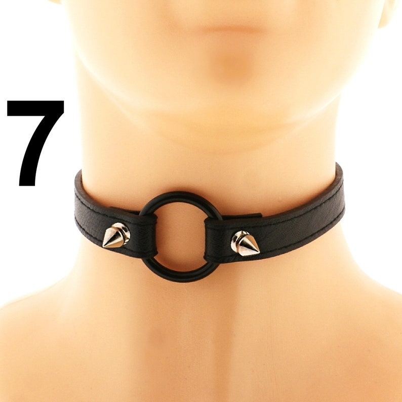For those who appreciate punk or rock aesthetics, this vegan leather choker is a must-have accessory. Its fashionable design showcases a heart ring, spiked embellishments, and an adjustable buckle closure, all in a sleek all-black color scheme.