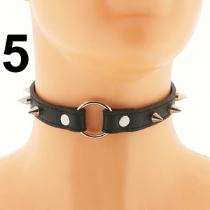 Unleash your inner rebel with our Black Vegan Leather Spiked Punk Choker. This adjustable buckle closure collar and ring necklace for women is the perfect accessory to showcase your punk aesthetic.