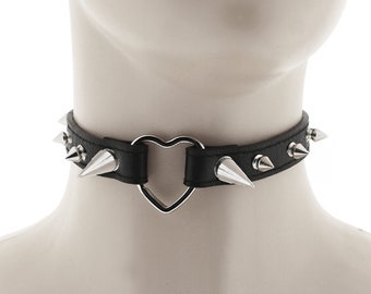 choker made of faux leather in all black with heart ring detail and spiked punk or rock inspired design adjustable buckle closure