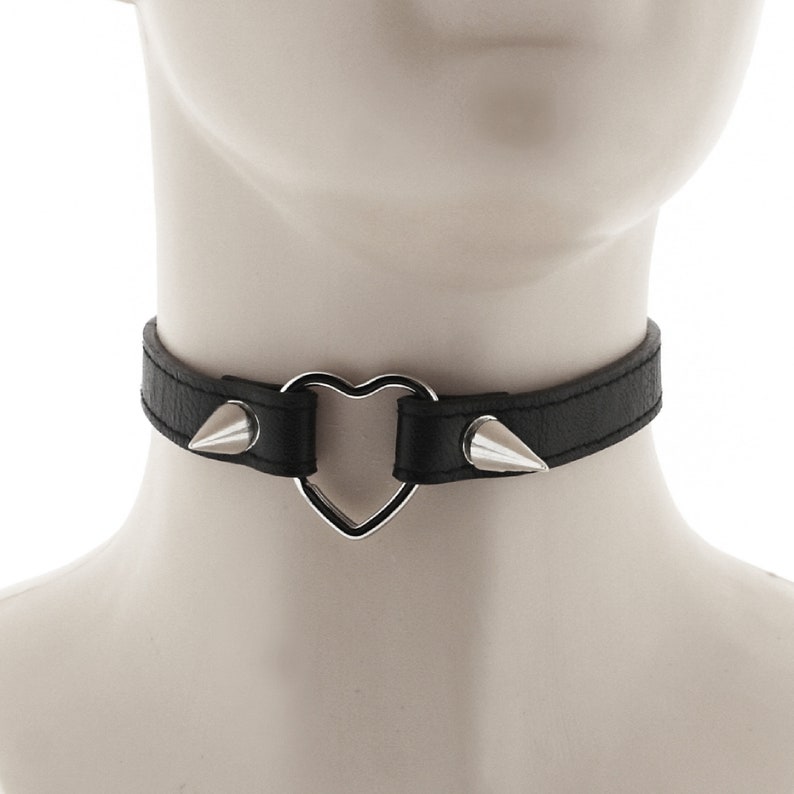 choker collar punk or rock style necklace made of faux leather in all black with heart ring and spiked and buckle for adjustable closure