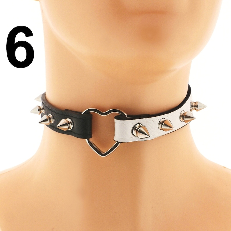 Elevate your accessory game with our trendy vegan faux leather chokers. Available in white and black with a heart ring accent and adjustable buckle closure.