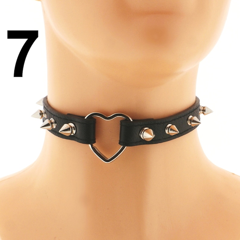 Elevate your style with our trendy black choker made of vegan faux leather. Complete with a unique ring detail and edgy spiked design. Shop now for an adjustable buckle closure!