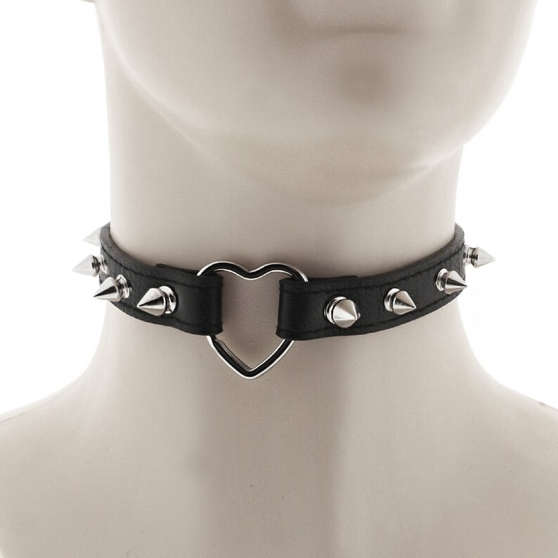 chic choker collar made of vegan faux leather in all black with heart ring detail and spiked punk or rock design adjustable buckle closure