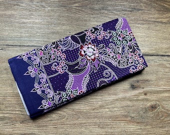 May include: Purple fabric with a white floral pattern. The fabric has a paisley design with small white dots throughout.