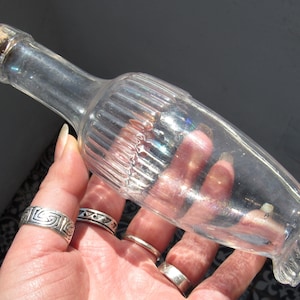 Vintage Apothecary Bottle / a clear glass bottle with ornate shape and patterning, faint rainbow patina and hand-carved cork stopper